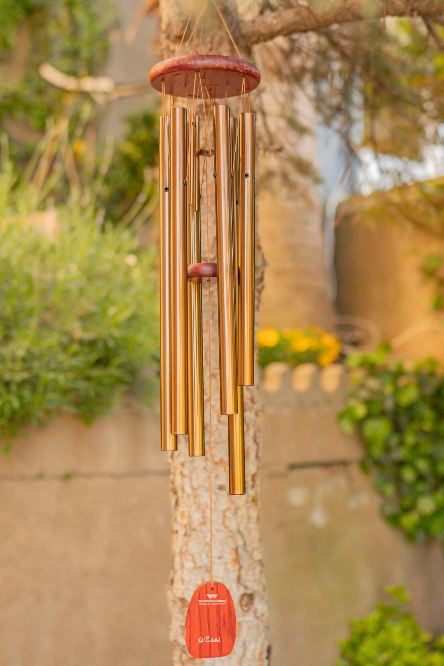 Outdoor accents collection featuring wind chimes, rain chains, garden stakes, decorative fences, and hardscaping stones for yard decor