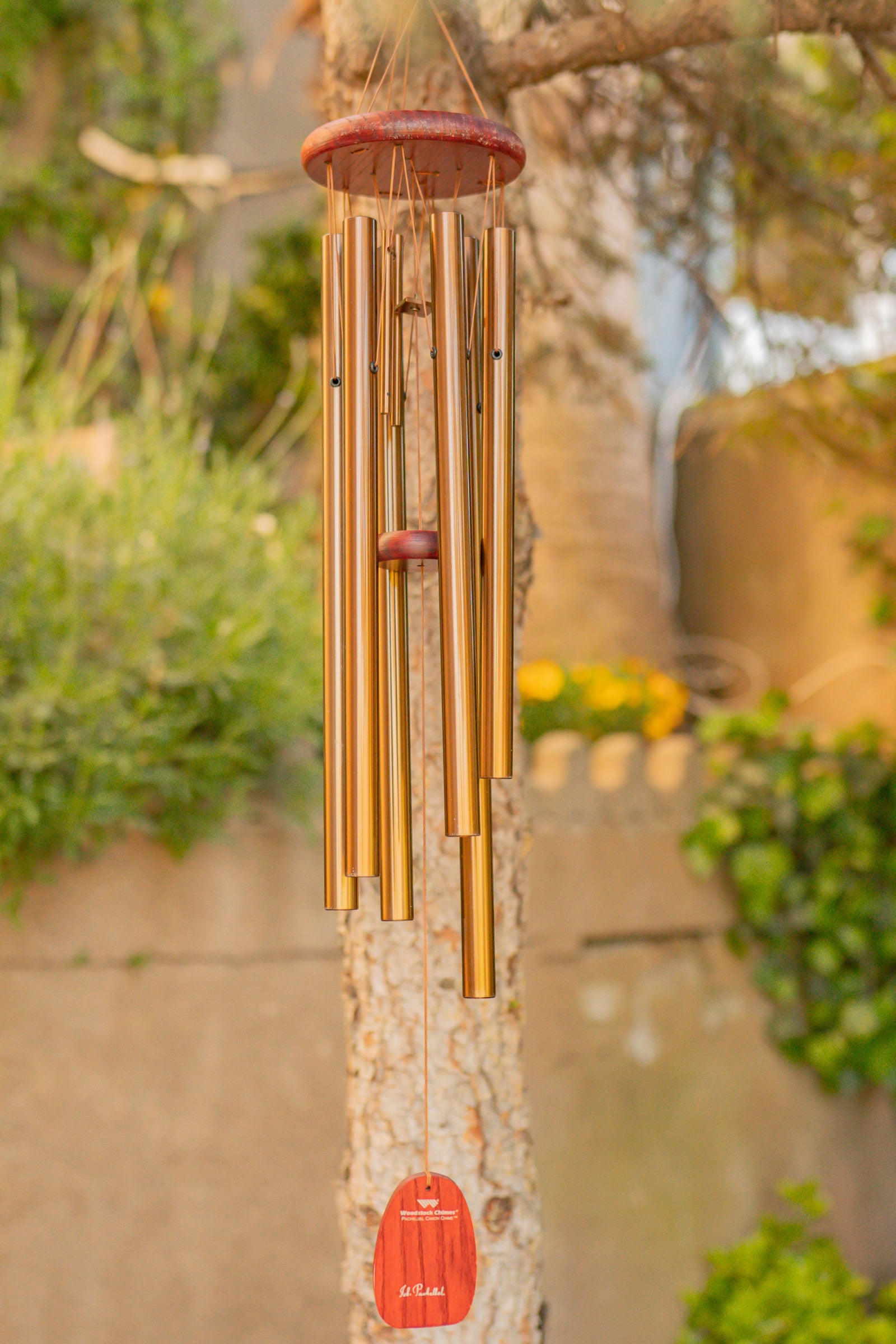 Outdoor accents collection featuring wind chimes, rain chains, garden stakes, decorative fences, and hardscaping stones for yard decor