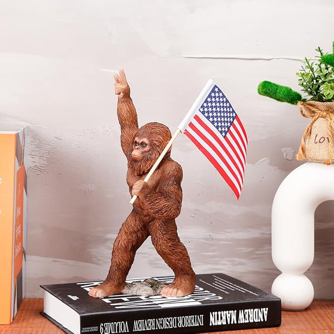 The Bigfoot Statue Holding The National Flag, A 10.4-Inch Resin Statue, Sasquatch Gifts. Bigfoot Decor is Suitable for Outdoor and Indoor Decor. Father's Day