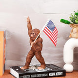 The Bigfoot Statue Holding The National Flag, A 10.4-Inch Resin Statue, Sasquatch Gifts. Bigfoot Decor is Suitable for Outdoor and Indoor Decor. Father's Day