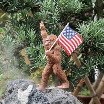 The Bigfoot Statue Holding The National Flag, A 10.4-Inch Resin Statue, Sasquatch Gifts. Bigfoot Decor is Suitable for Outdoor and Indoor Decor. Father's Day