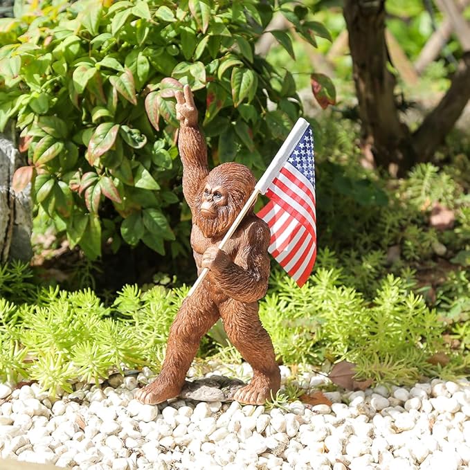 The Bigfoot Statue Holding The National Flag, A 10.4-Inch Resin Statue, Sasquatch Gifts. Bigfoot Decor is Suitable for Outdoor and Indoor Decor. Father's Day